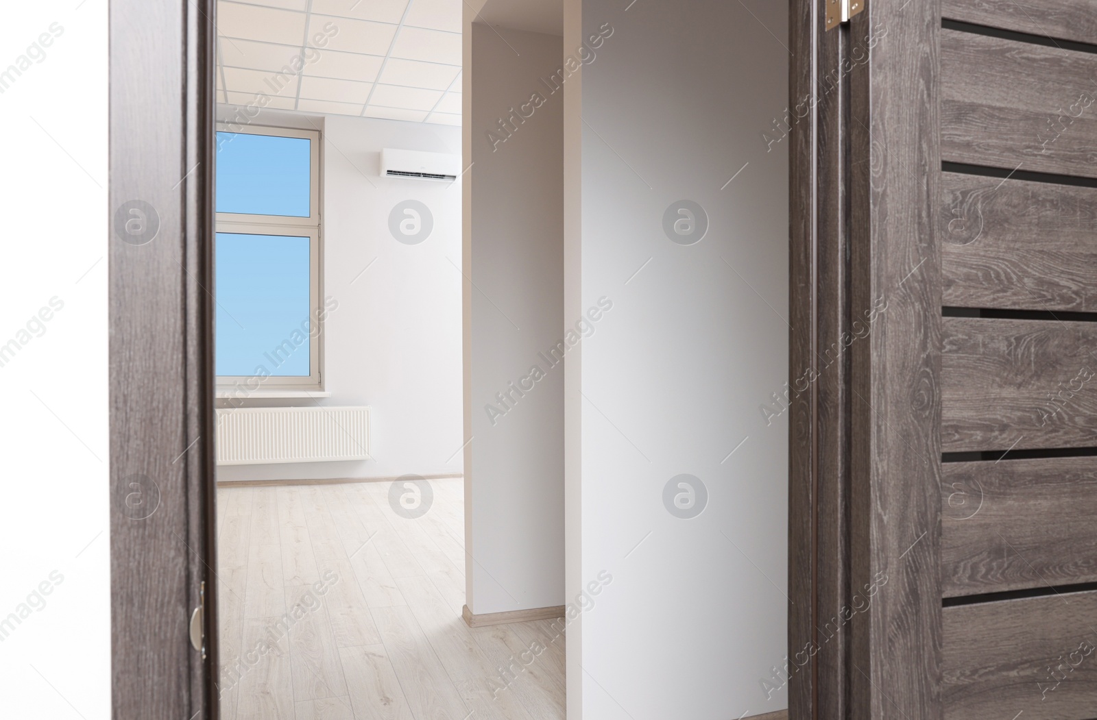 Photo of Empty office room with white walls and door. Interior design