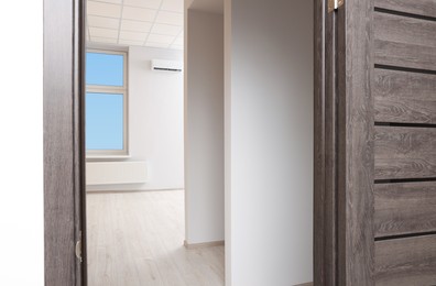 Photo of Empty office room with white walls and door. Interior design