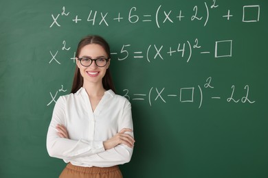 Portrait of young math’s teacher near chalkboard