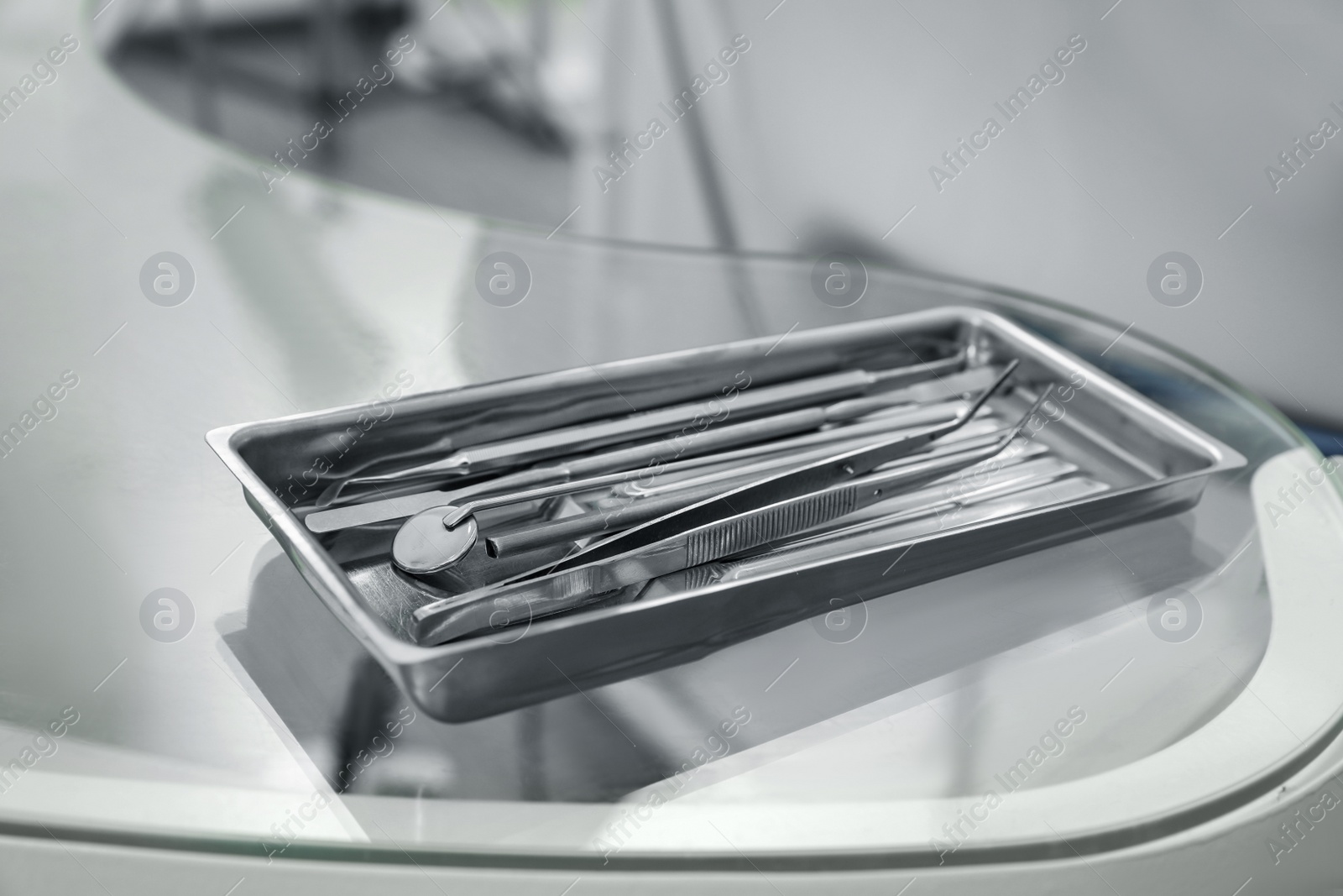 Photo of Professional dentist tools on glass table in clinic