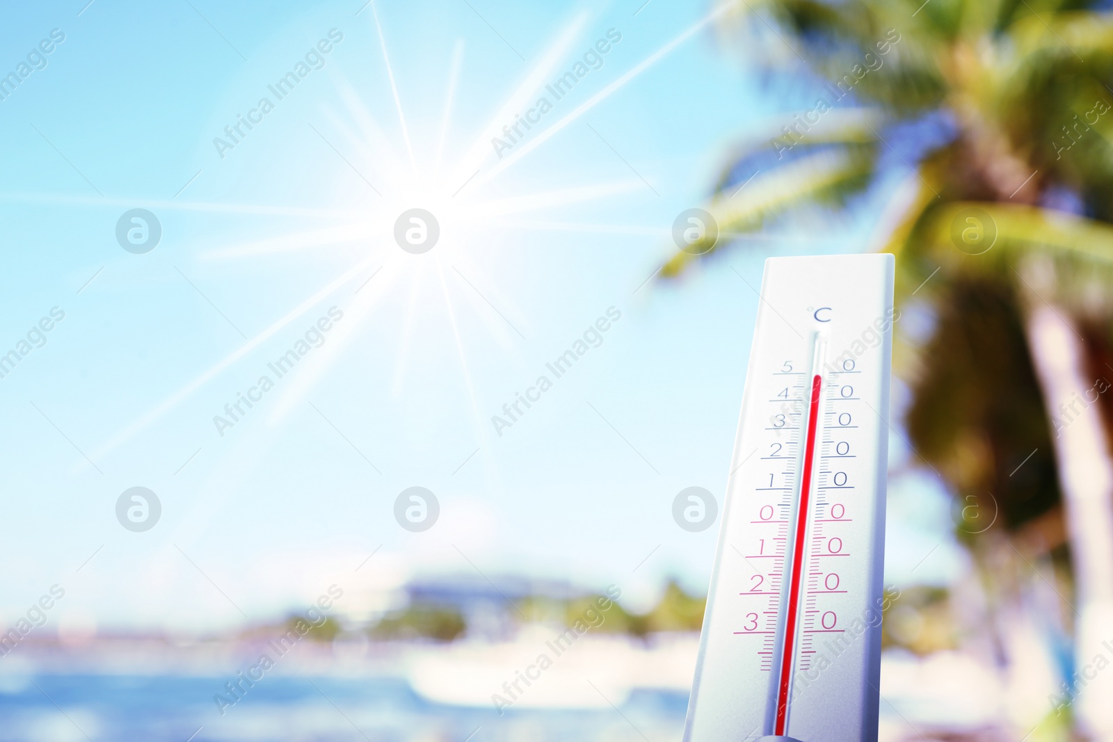 Image of Thermometer showing high temperature on beach during very hot day in summer