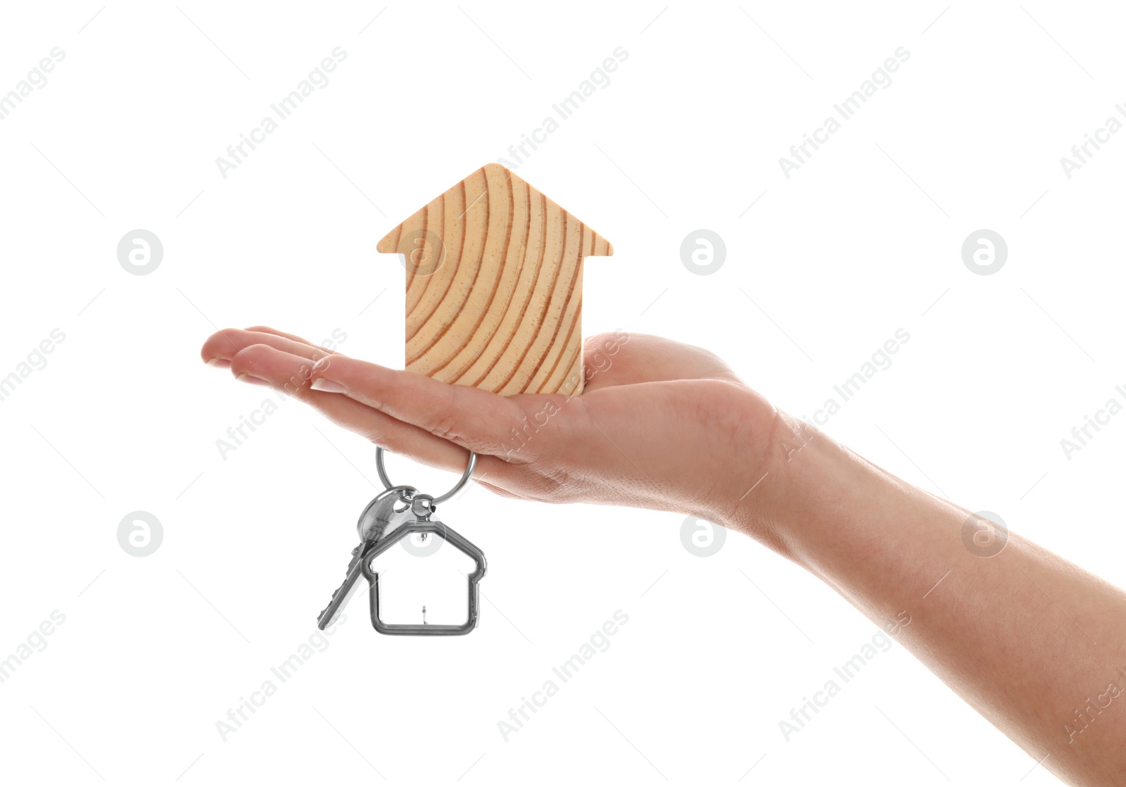 Photo of Real estate agent holding house figure and key on white background, closeup