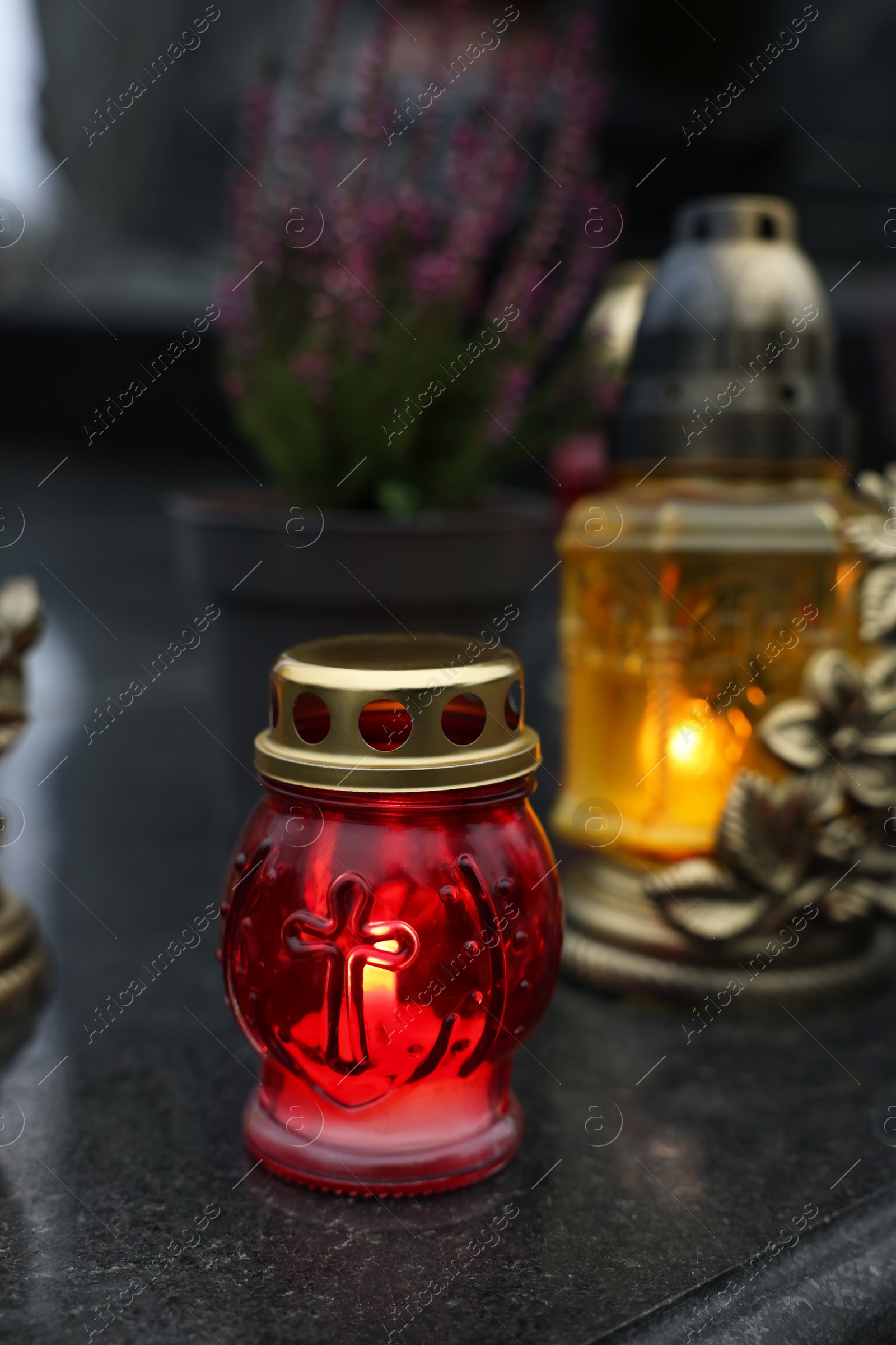 Photo of Grave lights on granite surface at cemetery