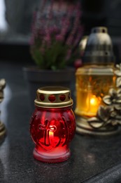 Photo of Grave lights on granite surface at cemetery