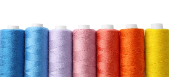 Photo of Set of different colorful sewing threads on white background, top view