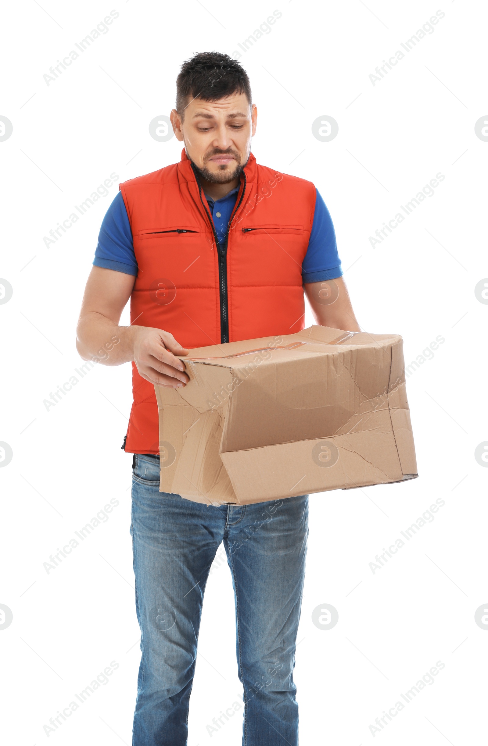 Photo of Emotional courier with damaged cardboard box on white background. Poor quality delivery service