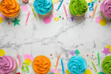 Photo of Colorful birthday cupcakes on marble table, flat lay. Space for text