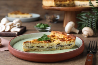 Delicious pie with mushrooms and cheese on brown wooden table, closeup
