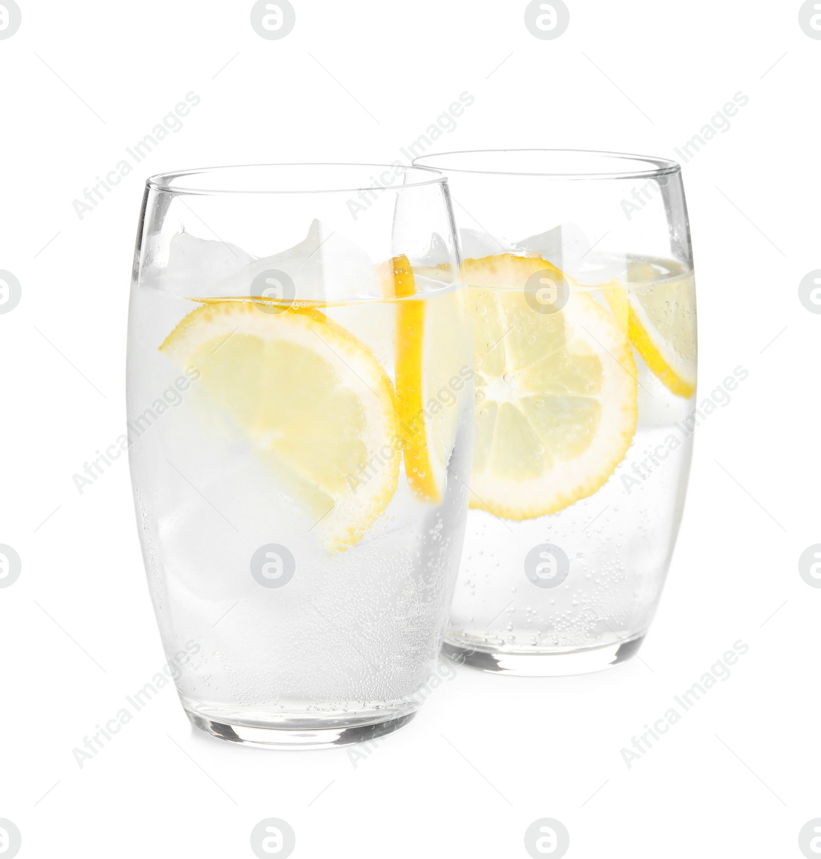 Photo of Soda water with lemon slices and ice cubes on white background