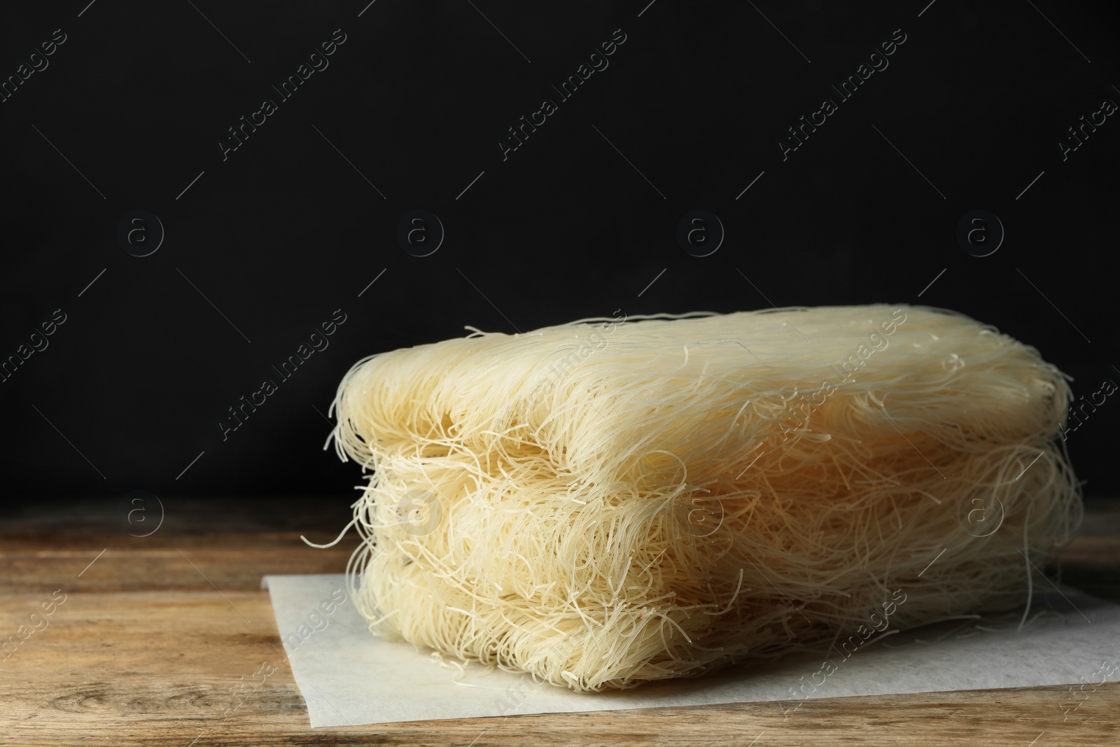 Photo of Block of rice noodles on wooden table, closeup