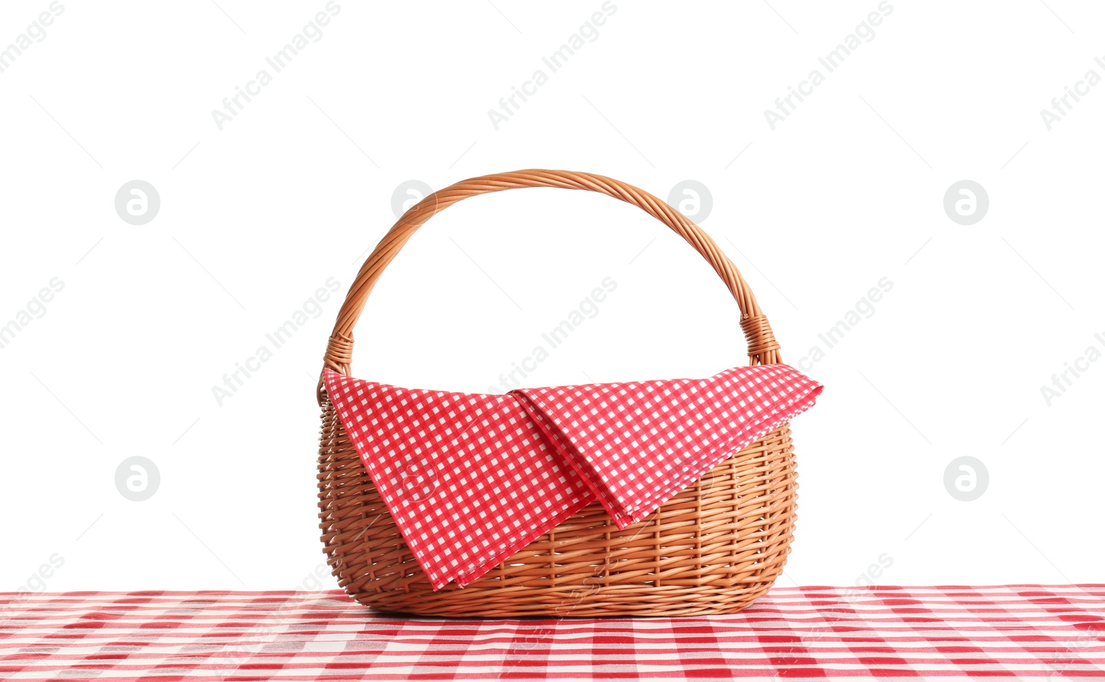 Photo of Empty picnic basket on checkered tablecloth against white background