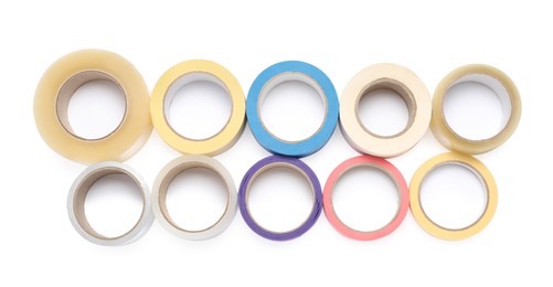 Many different rolls of adhesive tape on white background, top view