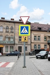 Post with different road signs on city street