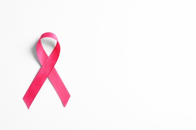 Photo of Pink ribbon on white background, top view. Cancer awareness
