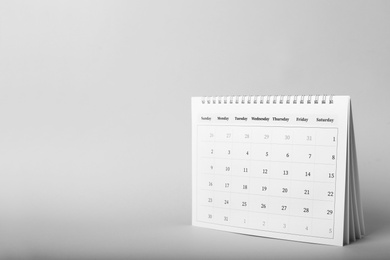 Photo of Paper calendar on grey background, space for text. Planning concept