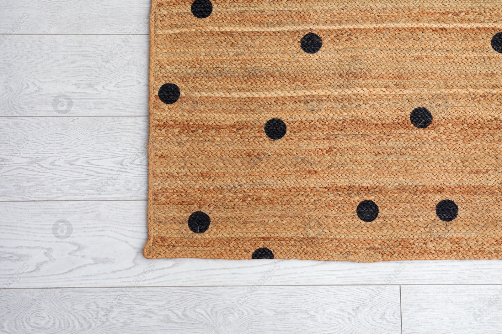 Photo of Stylish rug with dots on floor, top view