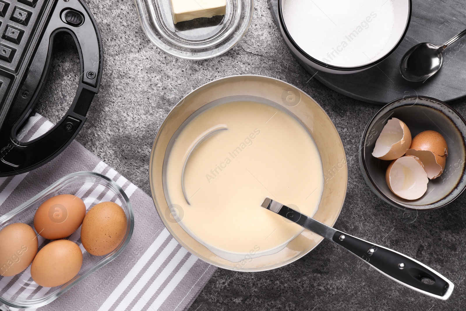 Photo of Flat lay composition with ingredients for cooking Belgian waffles on grey table