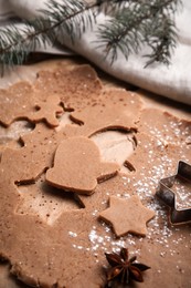 Making Christmas cookies. Raw dough, anise and cutter on table, closeup