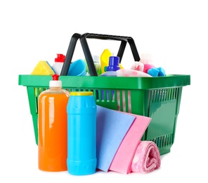 Green shopping basket with different household chemicals on white background