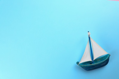 Photo of Toy ship on colorful background, top view. Space for text
