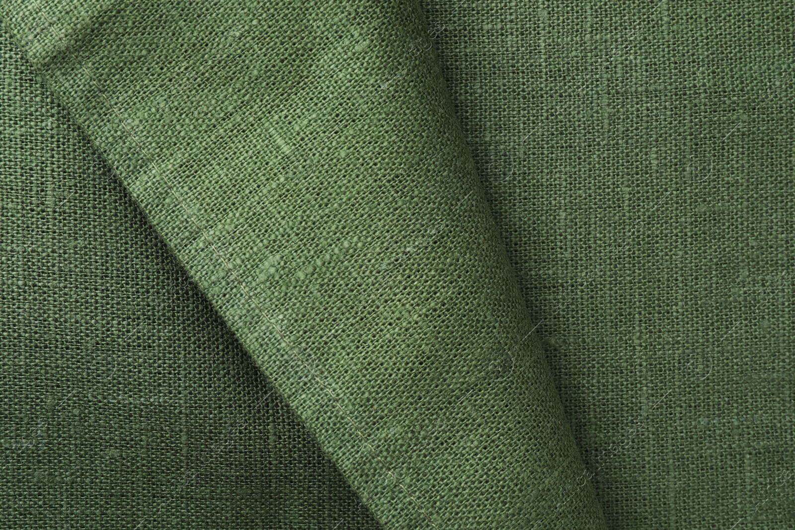 Photo of Texture of green fabric as background, top view