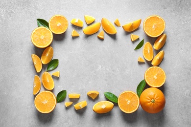 Photo of Flat lay composition with ripe oranges and space for text on grey background