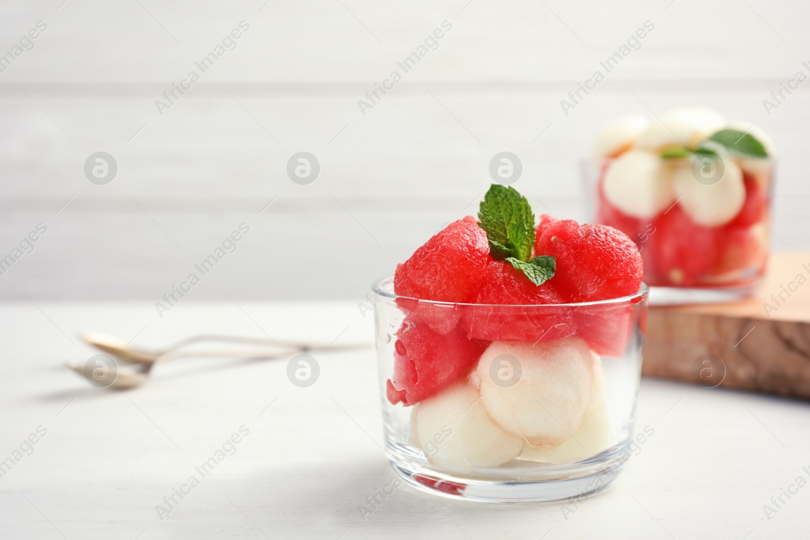 Photo of Bowl with melon and watermelon balls on table. Background with space for text