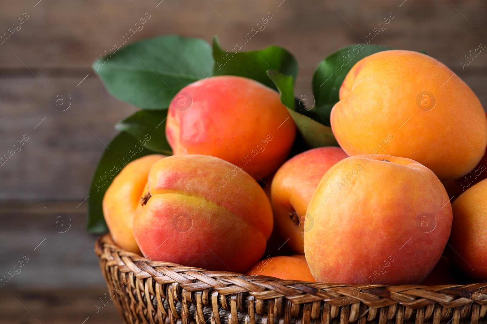 Photo of Delicious fresh ripe apricots on wooden background, closeup