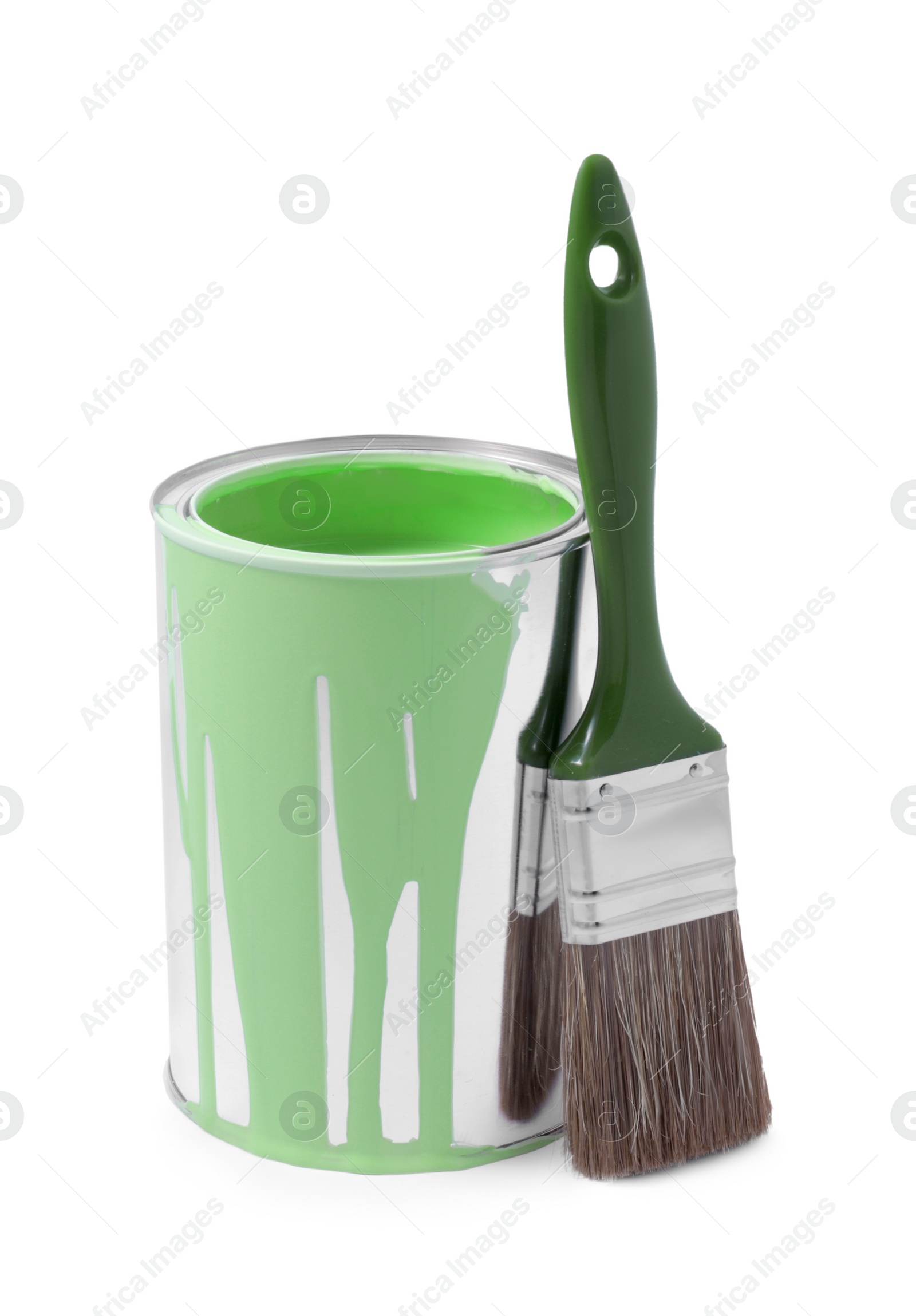 Photo of Can of light green paint and brush isolated on white