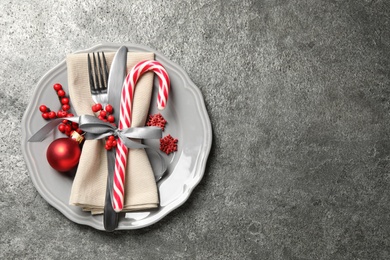 Beautiful Christmas table setting on grey background, top view. Space for text