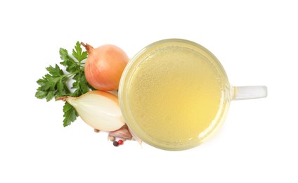 Hot delicious bouillon in glass cup and ingredients on white background, top view