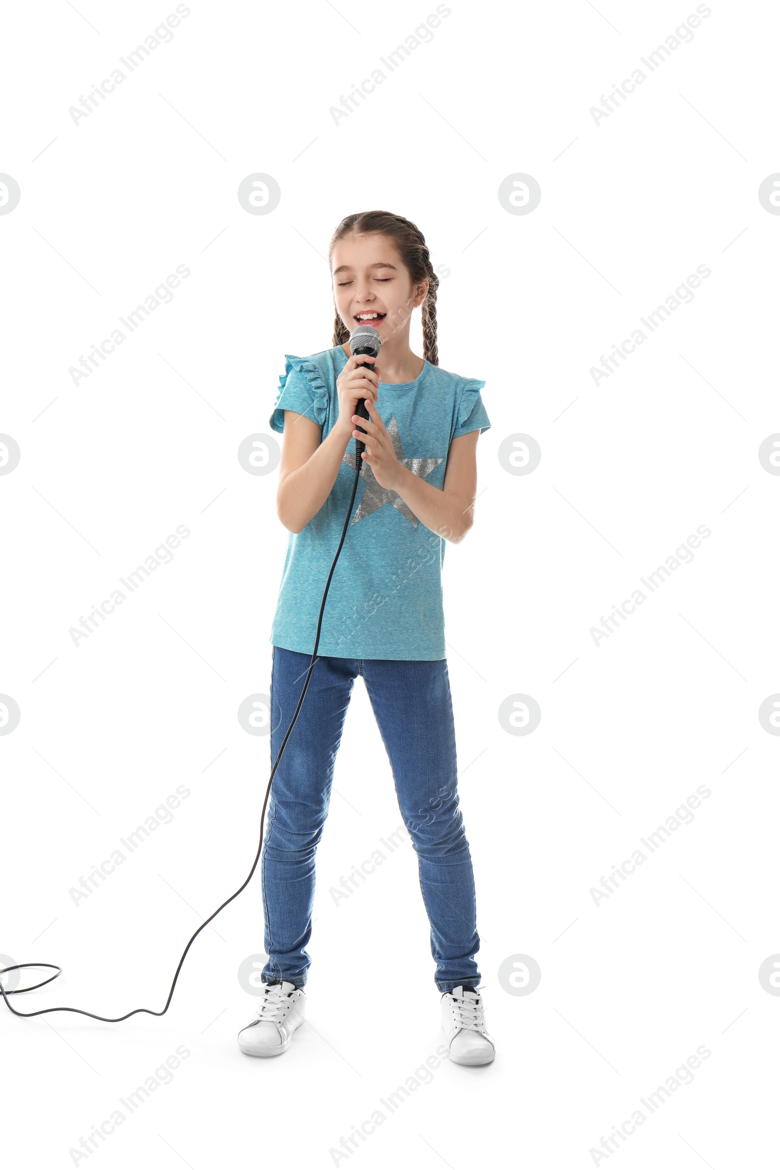 Photo of Cute girl singing in microphone on white background