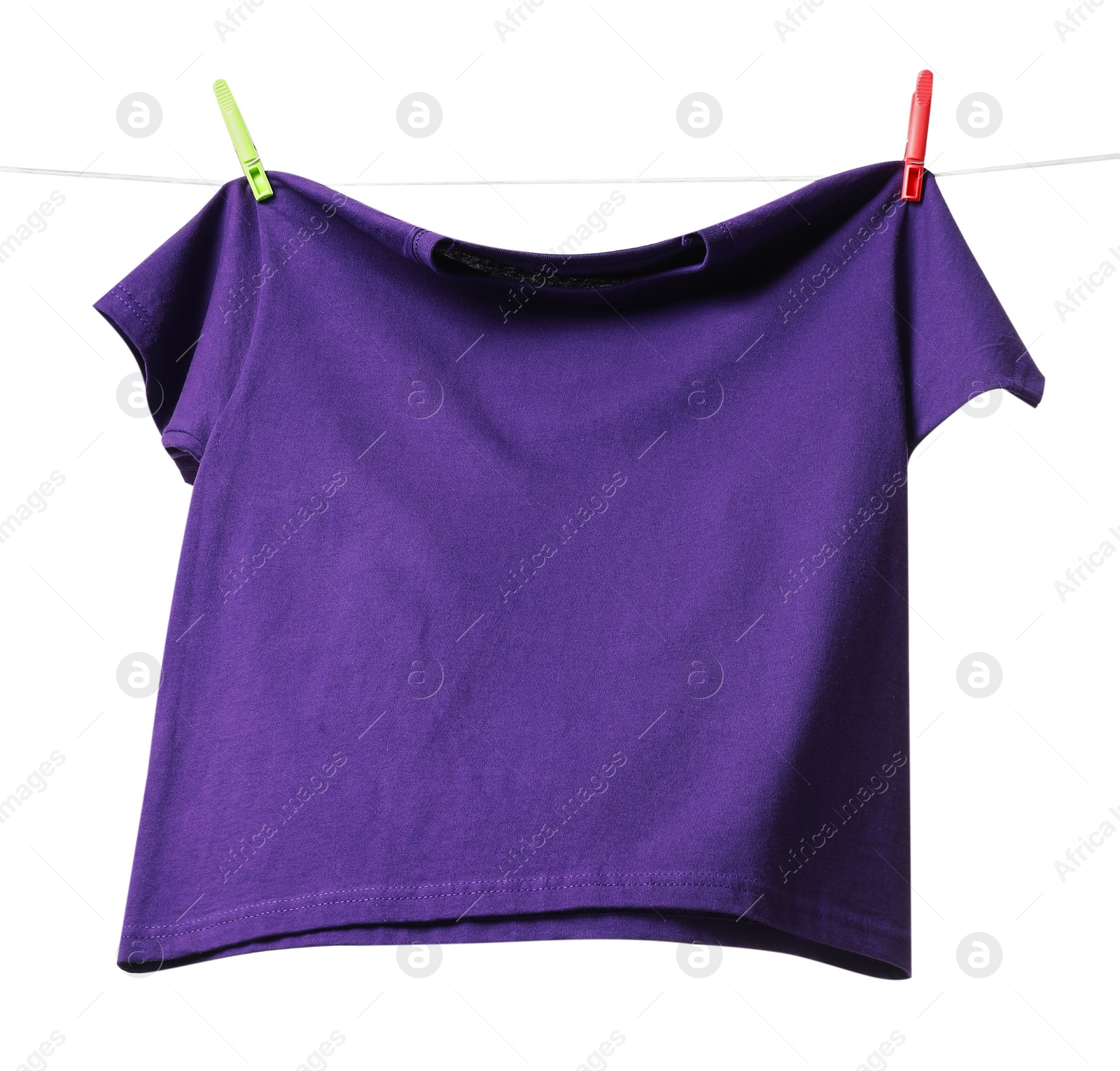 Photo of One purple t-shirt drying on washing line isolated on white