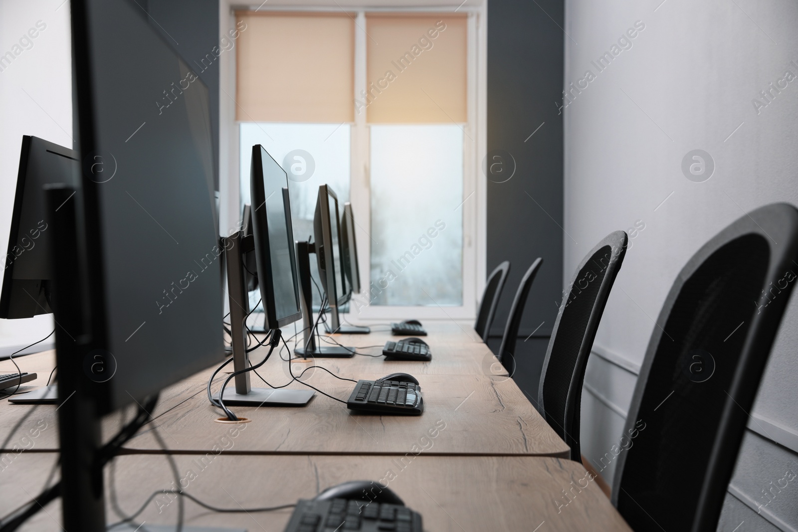 Photo of Many modern computers in open space office