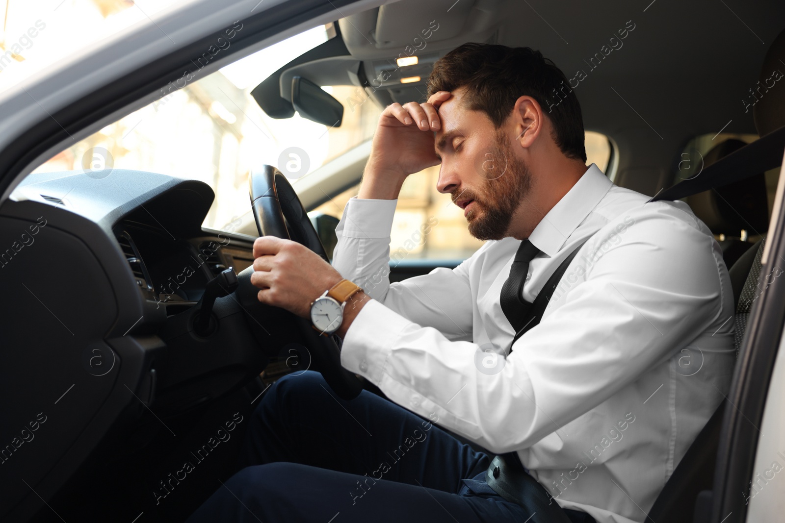 Photo of Stuck in traffic jam. Tired driver in his car