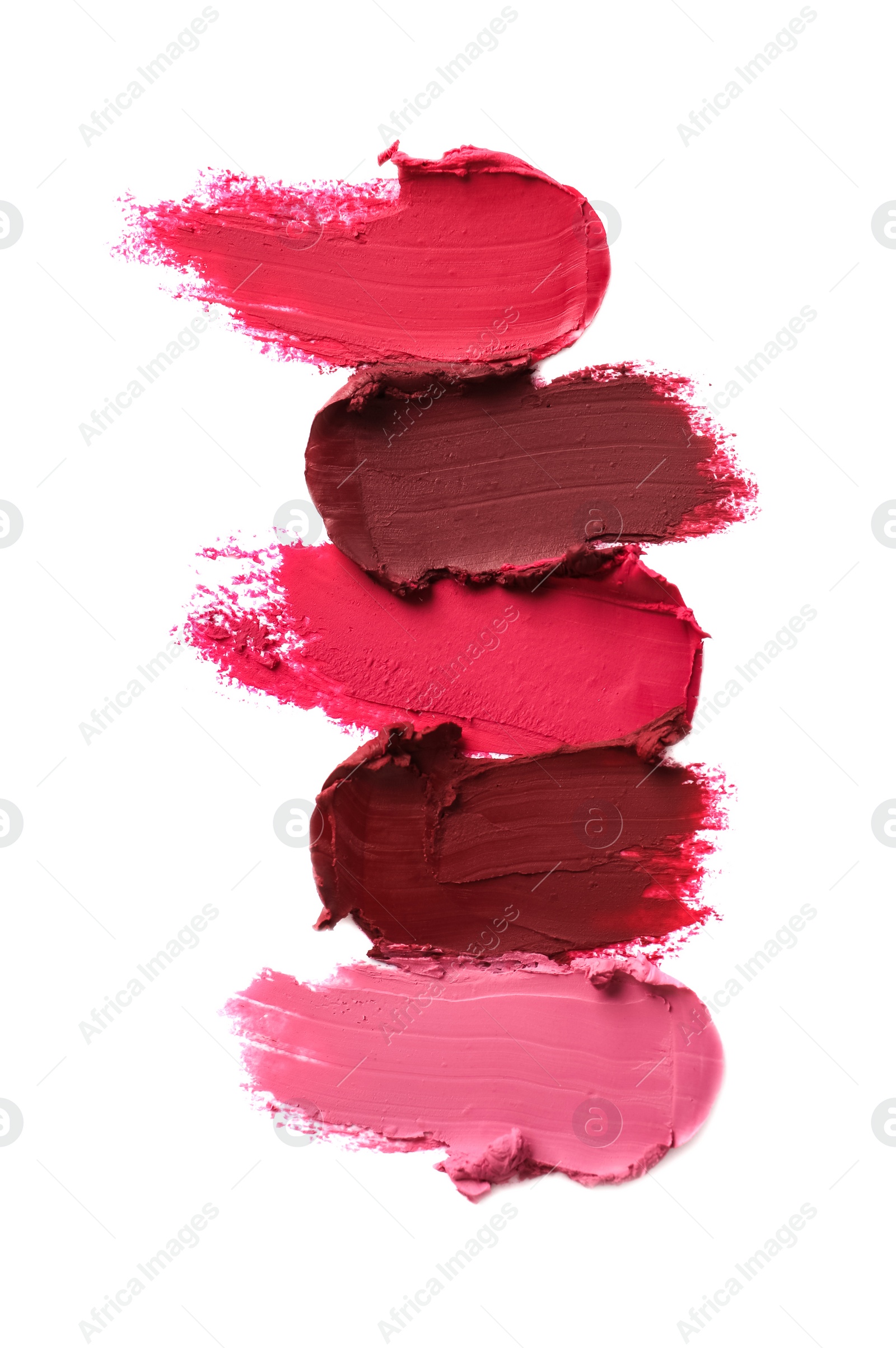 Photo of Smears of bright lipsticks on white background, top view