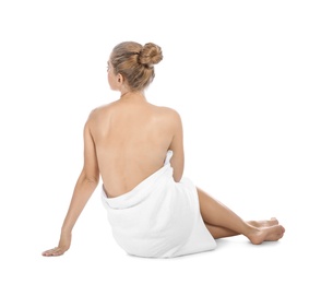 Photo of Young woman with soft towel sitting on white background