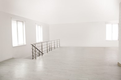 Photo of Empty room with windows and laminated floor