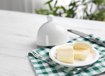 Dish with tasty fresh butter on table