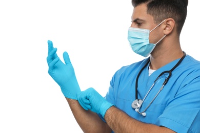 Photo of Doctor in protective mask putting on medical gloves against white background