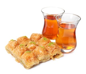 Photo of Delicious baklava with pistachios and hot tea on white background