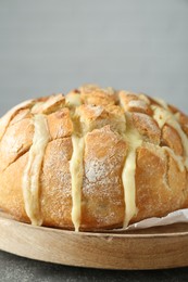 Freshly baked bread with tofu cheese on grey table, closeup