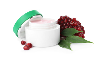 Photo of Jar with natural facial mask, pomegranate seeds and green leaves isolated on white