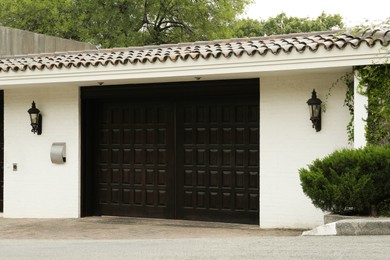 White wall with beautiful black gates. Exterior design