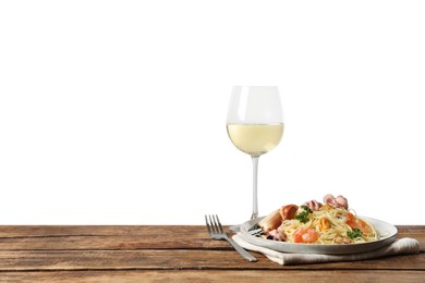 Delicious spaghetti with seafood served on wooden table against white background