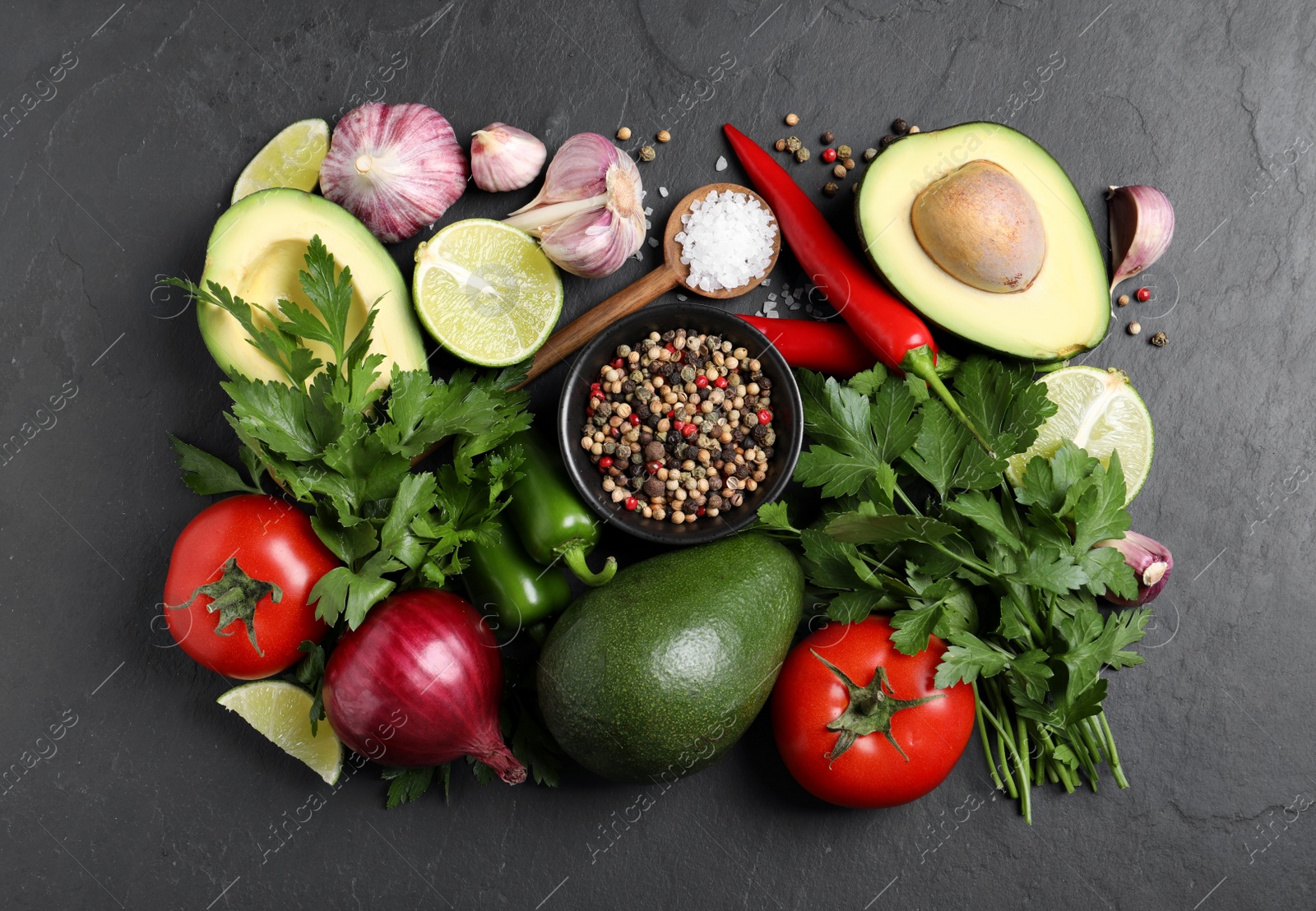 Photo of Fresh ingredients for guacamole on black table, flat lay