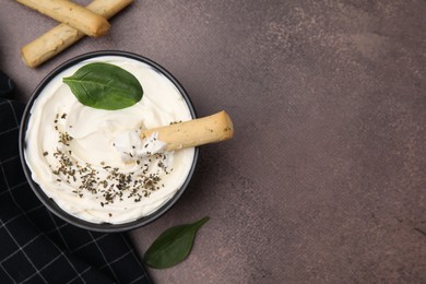 Delicious cream cheese with grissini stick and spices on grey table, flat lay. Space for text