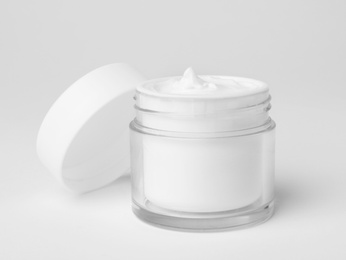 Photo of Jar of cosmetic product on light background