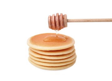 Photo of Pouring honey onto delicious pancakes on white background