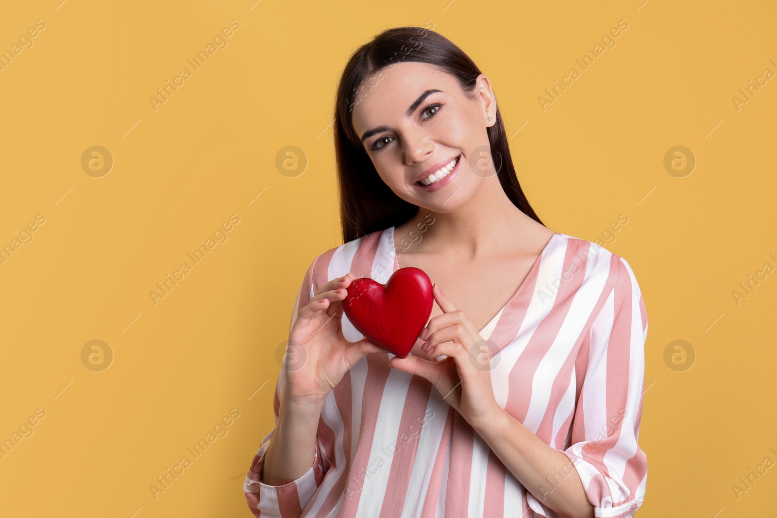 Photo of Portrait of young woman with decorative heart on color background